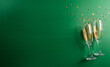 © Siam - Happy New year celebration background concept made from champagne glass on green background.