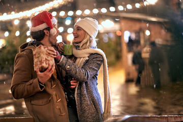 Wall Mural - Man and woman outdoor in winter drinking hot tea and enjoy at romantic Christmas night