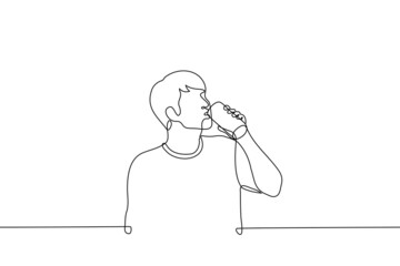 Wall Mural - man stands and drinks beer, energy drink or soda from aluminum can - one line drawing vector. concept of drinking alcohol or unhealthy sweet drinks