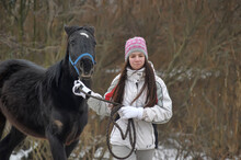 Girl In Winter With A Horse In The Paddock