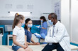 © DC Studio - African american pediatrician doctor analyzing disease symptoms expertise explaining healthcare treatment to parent during clinical examination in hospital office. Medical team with face mask