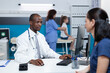 © DC Studio - African american pediatrician doctor explaining disease symptoms to patient mother typing medical treatment on computer keyboard. Specialist man working in hospital office during clinical consultation