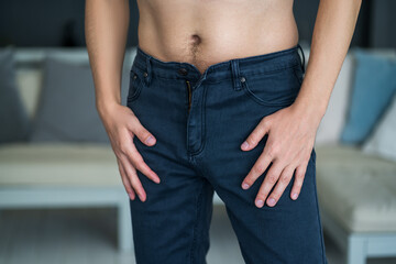 Man in blue jeans at home