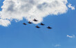 A link of jet military, fighters, aircraft perform a maneuver against the background of the clouds of the sky