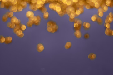 Wall Mural - blurred golden lights on a purple background
