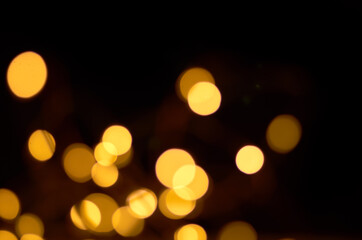 Wall Mural - golden defocused lights on a black background