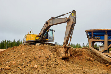 Wall Mural - The excavator in the quarry digs sand