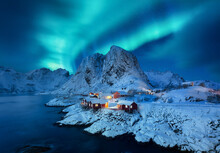 Aurora Borealis, Lofoten Islands, Norway. View On The Houses In The Hamnoy Village, Lofoten Islands, Norway. Iconic View In Norway. High Resolution Photo.
