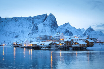 Canvas Print - View on the house in the Sarkisoy village, Lofoten Islands, Norway. Landscape in winter time during blue hour. Mountains and water. Travel - image