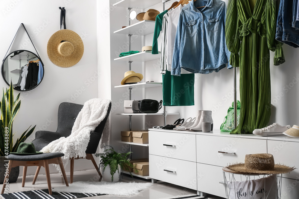 Female clothes, shoes and accessories in wardrobe