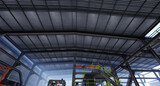 Fototapeta Miasto - Industrial factory structure with mechanical machines for production with galvanized steel shed roof