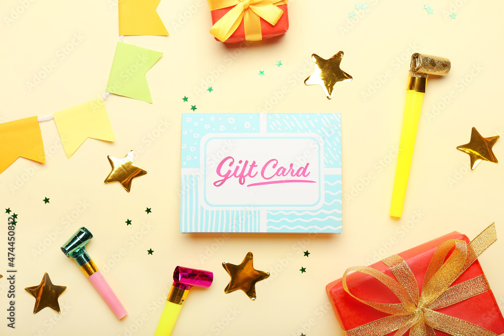 Composition with gift card and festive decor on color background