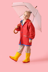 Little girl in stylish raincoat and with umbrella on color background