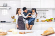 © Art_Photo - Portrait of enjoy happy love asian family father and mother with little asian girl daughter child play and having fun cooking food together with baking cookie and cake ingredient on kitchen