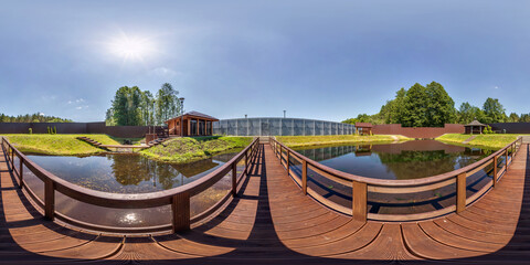 Wall Mural - full seamless spherical hdr 360 panorama on wooden pedestrian bridge over lake near vacation home in equirectangular projection with zenith and nadir, VR AR content.