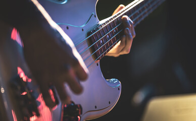 Wall Mural - Close-up of a man playing the bass guitar.