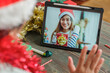 © weedezign - Christmas and new year  video call with friend with tablet together at home