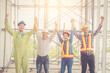 © Pornnarong - Engineer and worker team shake hand and arm up for congratulation to agree joint business at construction site.