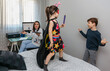 © David Pereiras - Children playing bothering their mother who is teleworking at home. Conciliation family work concept