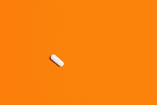 Orange Pills On White Background