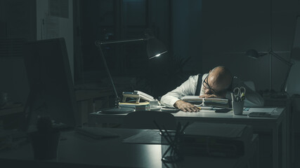 Wall Mural - Stressed businessman sleeping at desk