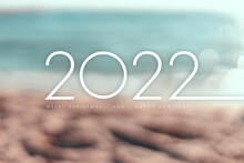 Numbers 2022 On Golden Sand Beach Blurry Background.