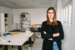 © contrastwerkstatt - Confident happy young businesswoman in a large office