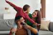 © Prostock-studio - Portrait of cheerful happy Arab family having fun at home