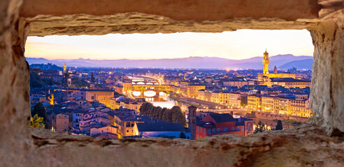 Wall Mural - Florence cityscape panoramic evening view through stone window