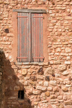 Window With Shutter In An Old Stone Wall In Provence, France.
