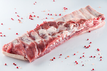 Wall Mural - raw pork ribs with spices on a white background