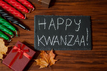 Kwanzaa African American Holiday. Seven Candles Red, Black And Green On Natural Wooden Background.