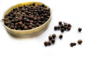 Pile of black pepper corns isolated.