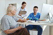© SHOTPRIME STUDIO - an elderly woman communicates with a doctor and a nurse in a health hospital