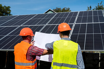 Two man finished installation of new solar panel station