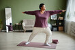 © Seventyfour - Full length portrait of active senior woman doing yoga at home and enjoying workout indoors, copy space