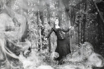 Wall Mural - Woman in a witch suit in a dense forest