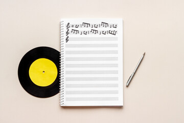 Wall Mural - Handwritten music sheets and vinyl record, top view. Compose music concept