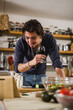 © cherryandbees - man preparing food in his kitchen