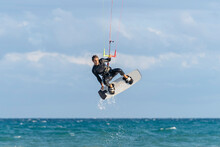 Man Kiteboarding Over Water On Vacation
