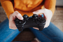 Young Woman Holding Game Controller At Home