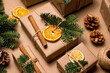 Still life christmas concept with gifts in craft paper decorated with natural materials. Wrapping presents for holidays.