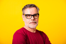 Man Wearing Eyeglasses Against Yellow Background