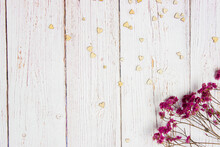 Red Flowers With Wooden Hearts On A Wooden Background.