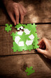 © Westend61 - Friends joining recycling symbol jigsaw puzzle on table