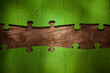 © Westend61 - Incomplete green jigsaw puzzle pieces on table