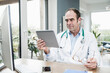 © Westend61 - Doctor staring at digital tablet in medical clinic