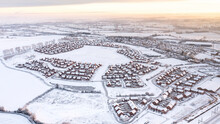 UK, England, Lichfield, Aerial View Of Snow-covered Suburb At Dusk