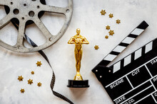 Golden Movie Award Statue With Film Reel Video Tape And Clapper Board