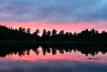 Red And Pink Evening Sunset Sky Over A Lake In Norway Sorrounded By Forests